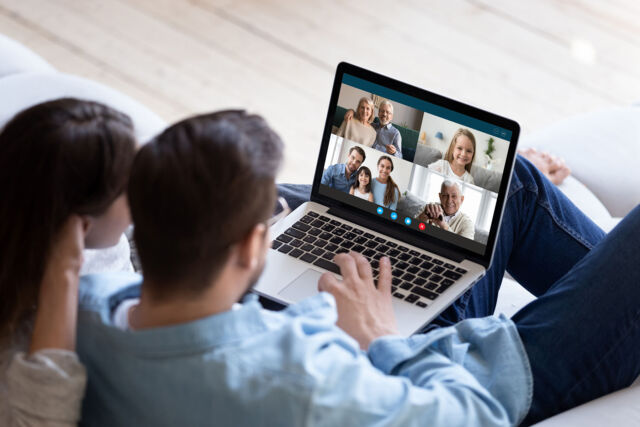 Couple chatting with relatives via videoconference video call application
